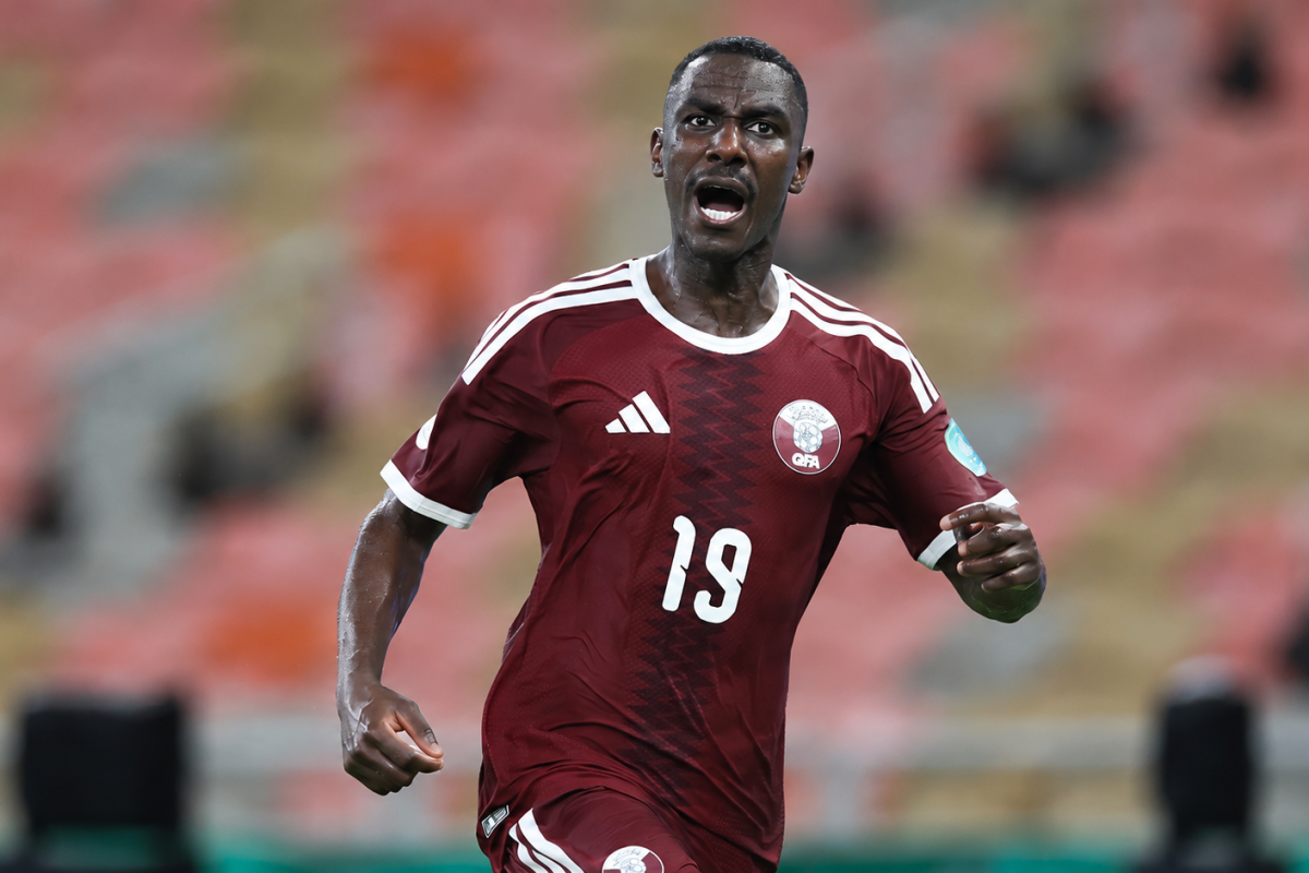 Qatar-footballer-framed-by-stadium-lights.png